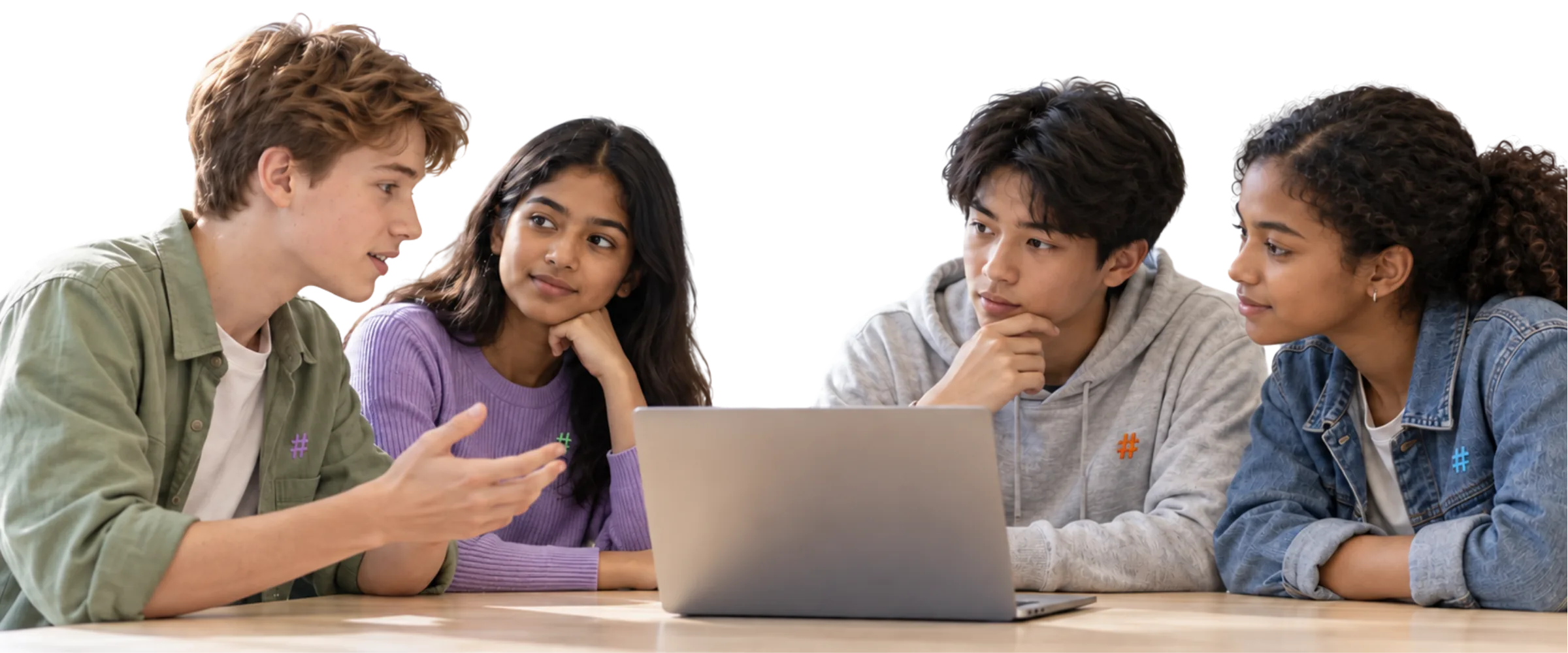 Four learners discussing their work around a laptop