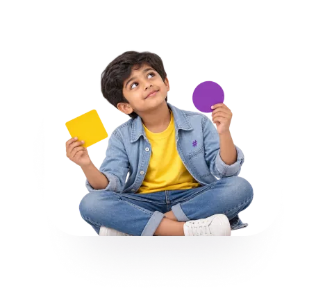 Child sitting cross-legged holding a yellow and a purple card
